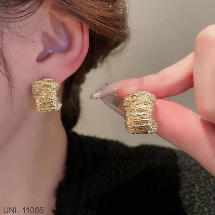 Model wearing the clean geometric Finoro Bold Gold Stud earrings with a simple black linen dress.