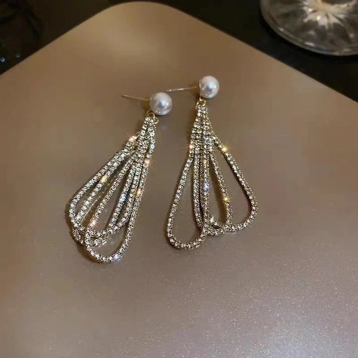 Side angle view detailing the flush, flat post backing design and lightweight structure of the dangling earring.